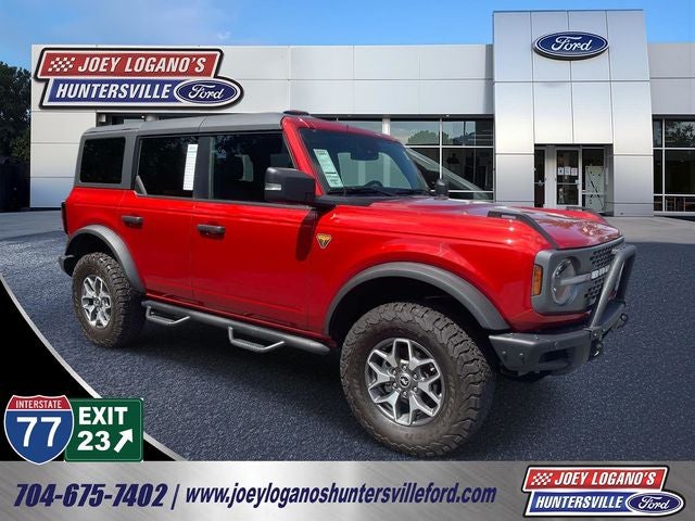 2024 Ford Bronco Badlands in Hot Pepper Red Metallic Tinted Clearcoat — front three-quarter view