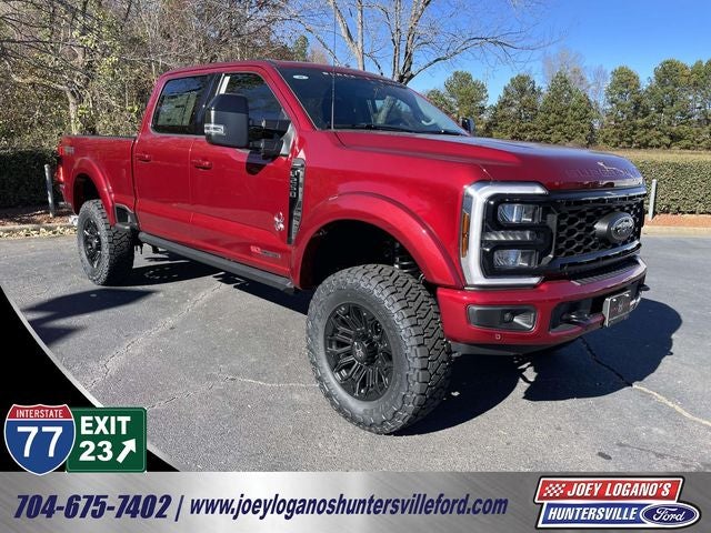 2026 Ford F-250SD Lariat BLACK WIDOW by FOX FACTORY in Ruby Red Metallic Tinted Clearcoat — front three-quarter view